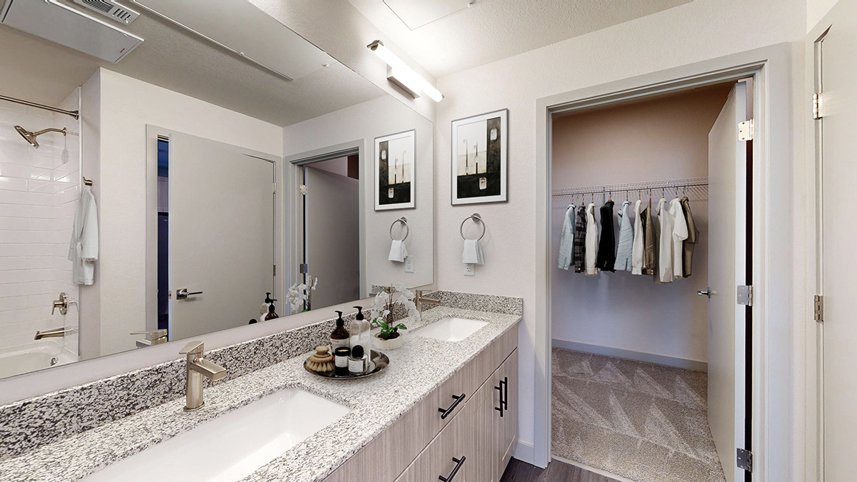 Model bathroom with double vanity and oversized closet